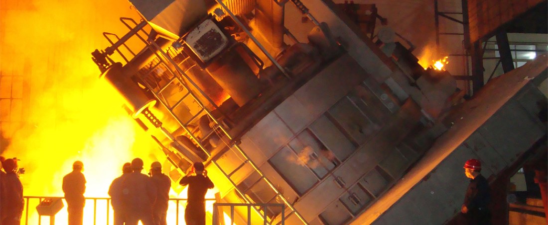 Molten metal glowing inside a steel furnace